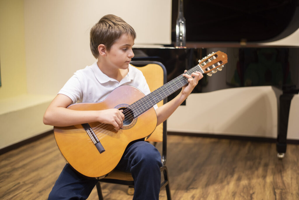 Beginner student learning guitar during a private lesson in Breda